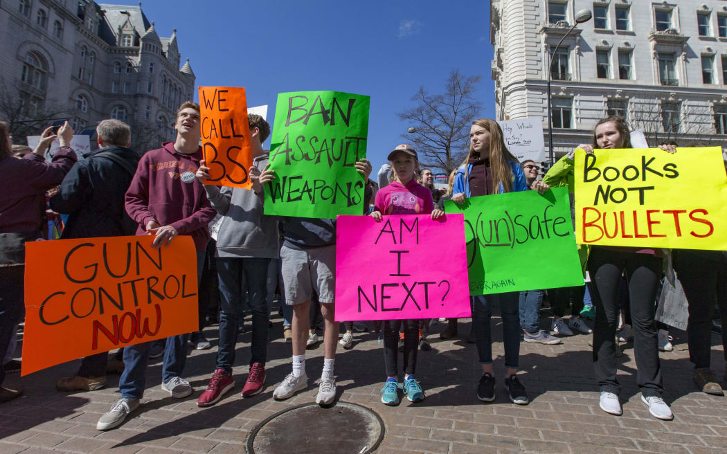 People pose with their signs at the March for Our Lives rally in Washington, DC.