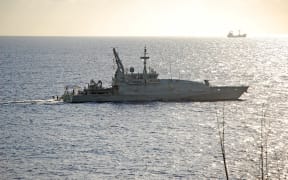 A Royal Australian Navy patrol boat off Christmas Island, where it refuels before continuing to search for asylum seeker and other boats, in April 2009.