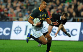 South African rugby player Cornal Hendricks makes a burst against the All Blacks in 2014.