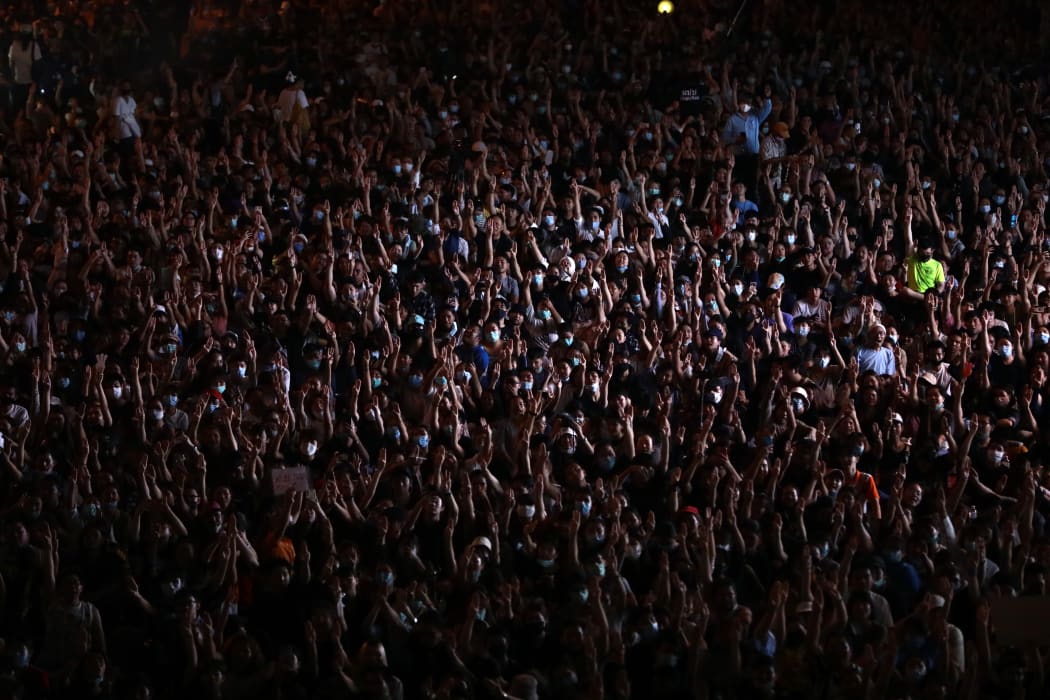 Pro-democracy protesters in Bangkok make the three-finger salute as they defy a ban on demonstrations, on 15 October 2020.
