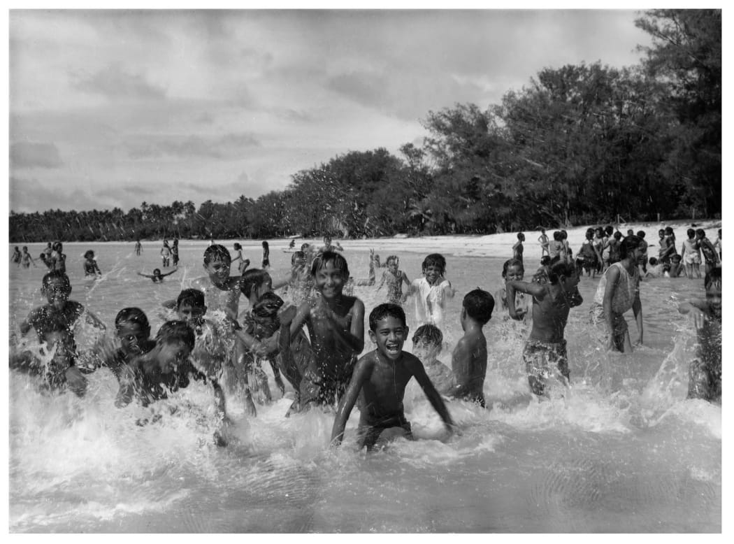 School children on a picnic enjoying the warm waters of Muri Lagoon, Rarotonga, Cook Islands.