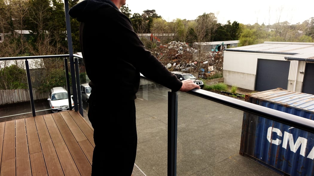 A a former prisoner standing on a balcony