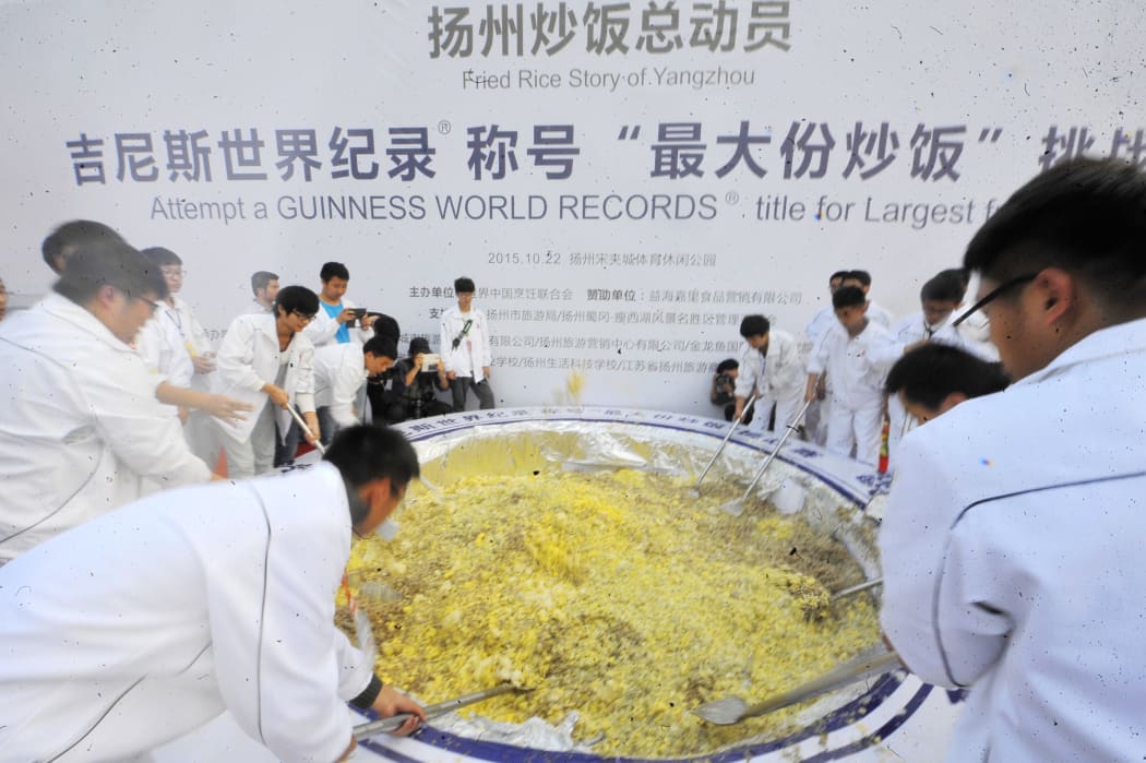 A group of 300 people teamed up to cook four tonnes of fried rice in Yangzhou in China's eastern province of Jiangsu on 22 October 2015.