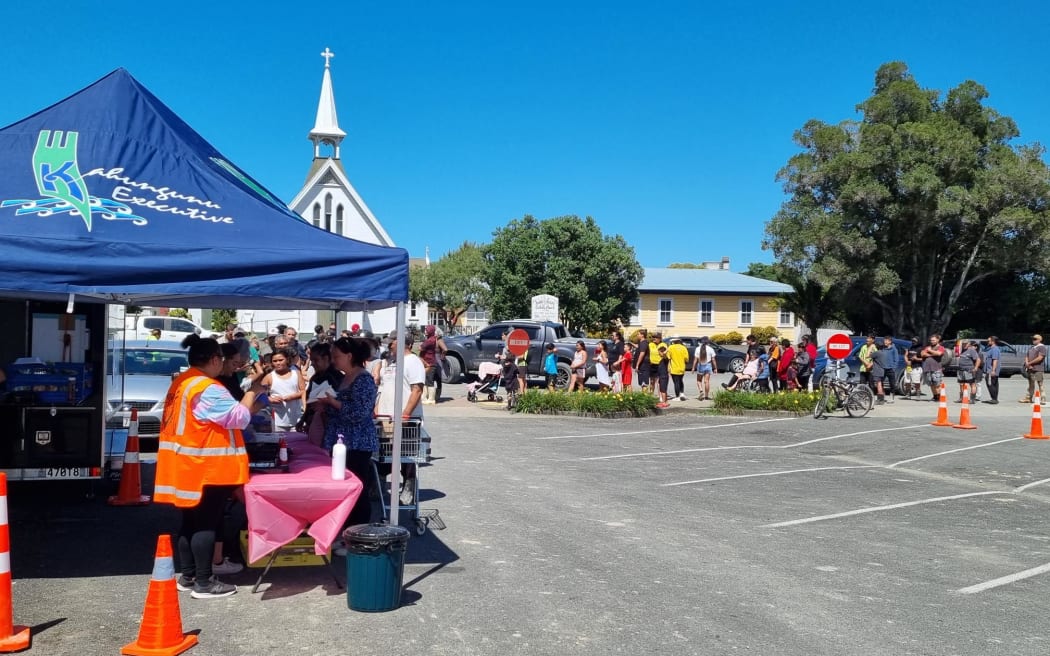 Locals line up for supplies in Wairoa, following Cyclone Gabrielle.