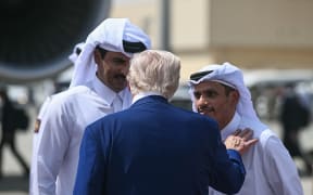 Qatar's Emir Sheikh Tamim bin Hamad al-Thani (L) and Prime Minister and Minister of Foreign Affairs Sheikh Mohammed bin Abdulrahman Al-Thani talk to US President Donald Trump ahead of his departure at the end of the Qatari leg of his regional tour, at the Al-Udeid air base southwest of Doha on May 15, 2025. (Photo by Brendan SMIALOWSKI / AFP)