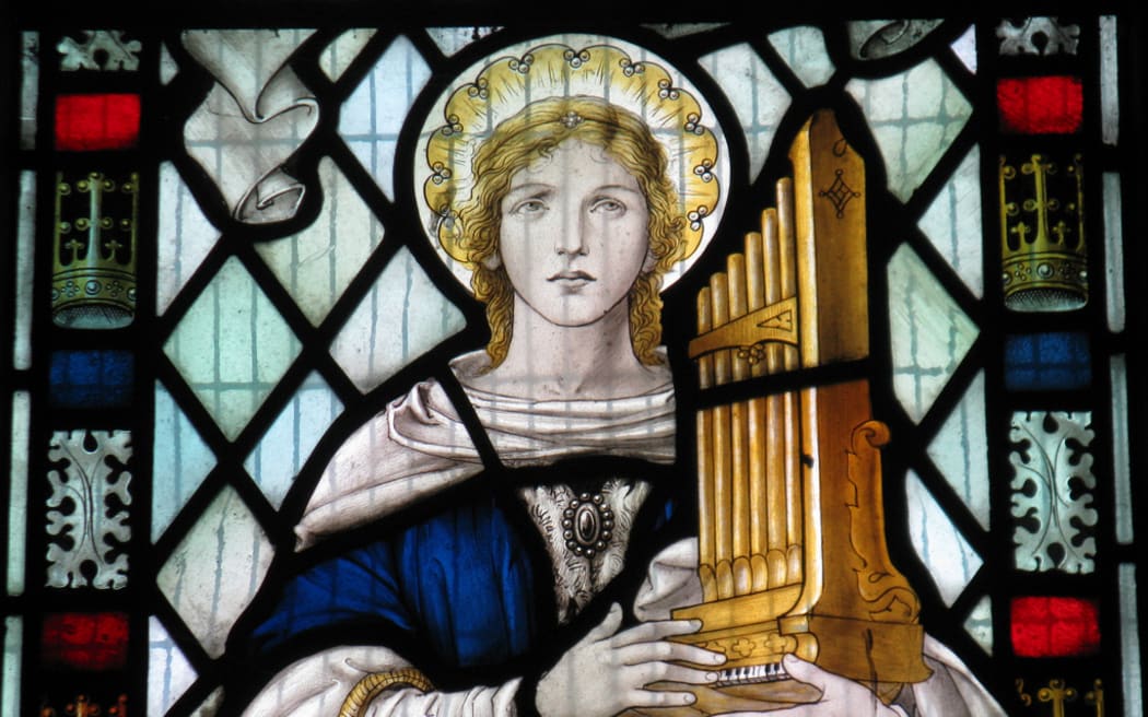 Saint Cecilia in a window in the church of St Mary the Virgin in Little Wymondley in Hertfordshire