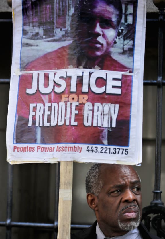 A demonstrator waits outside the Mitchell Courthouse-West for an announcement in the trial of Baltimore Police Officer Edward Nero, one of six officer charged in the arrest and death of Freddie Gray, May 23, 2016 in Baltimore, Maryland.