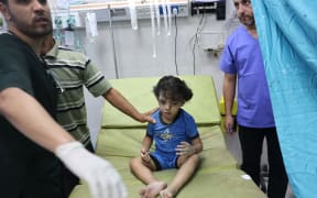 A Palestinian child is examined at the Nasser hospital where the wounded and dead are being brought following an Israeli strike, in Khan Yunis, in the southern Gaza Strip on October 26, 2023, amid the ongoing battles between Israel and the Palestinian group Hamas.