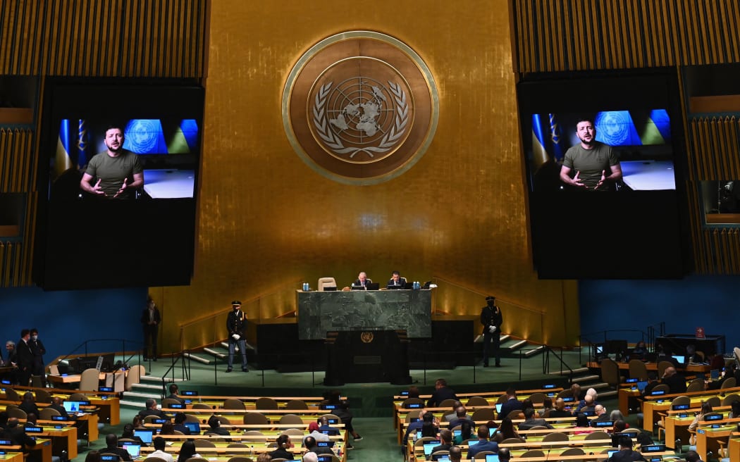 Ukrainian President Volodymyr Zelensky is seen on screen as he remotely addresses the 77th session of the United Nations General Assembly at the UN headquarters in New York City on September 21, 2022. (Photo by ANGELA WEISS / AFP)