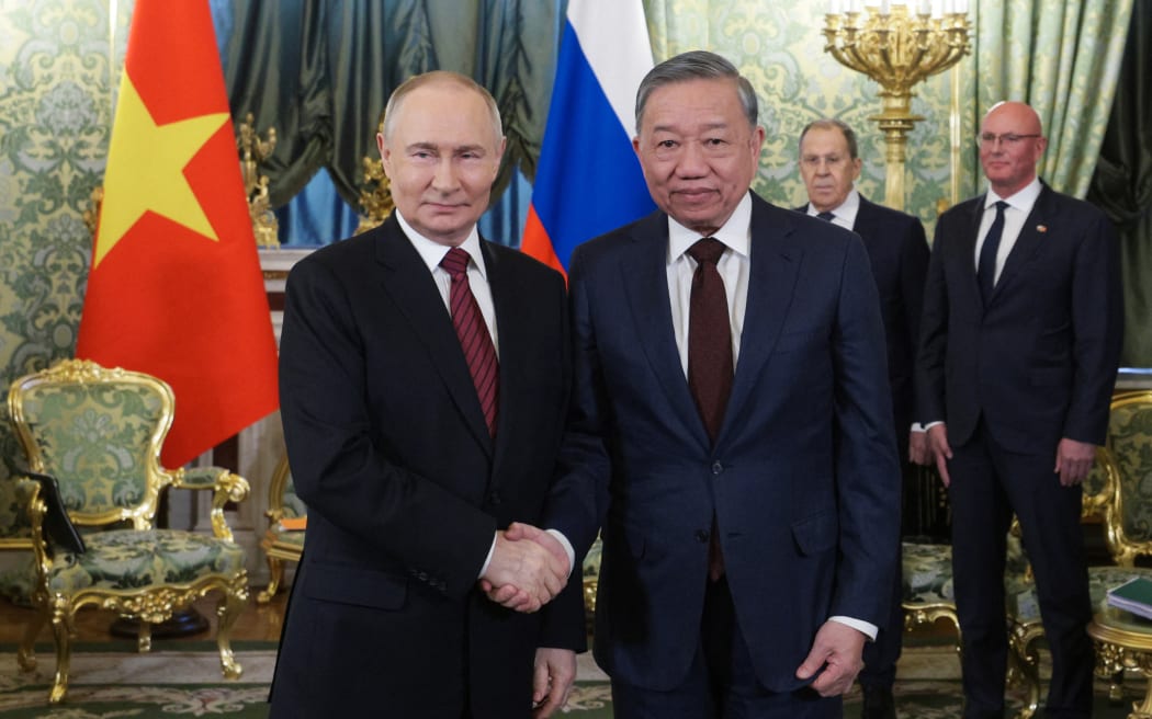 In this pool photograph distributed by Russian state agency Sputnik, Russia's President Vladimir Putin (L) shakes hands with the General Secretary of the Communist Party of Vietnam Tô Lâm in Moscow on May 10, 2025, during celebrations of the 80th anniversary of the Soviet Union's victory over Nazi Germany in World War Two. (Photo by Gavriil GRIGOROV / POOL / AFP) / ***EDITOR'S NOTE : THIS IMAGE IS DISTRIBUTED BY THE RUSSIAN STATE OWNED AGENCY SPUTNIK***