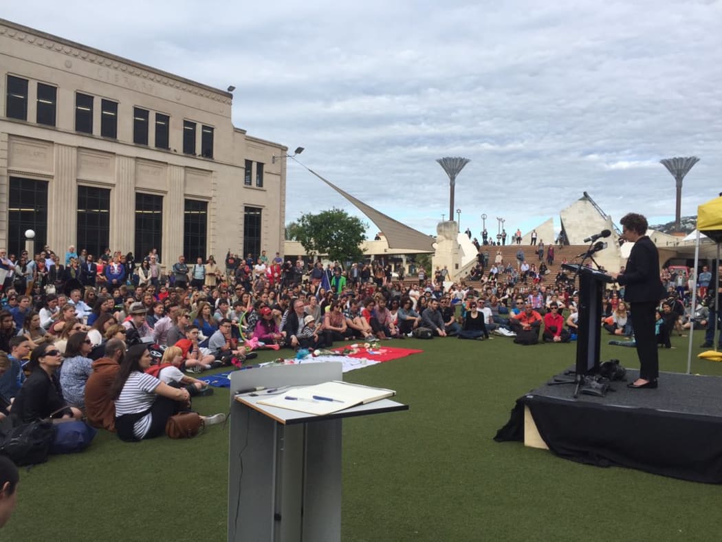 French Ambassador Florence Jeanblanc-Ridley speaks to a crowd of people gathered to pay their respects to the victims of the Paris attacks, in Wellington on 17 November 2015.