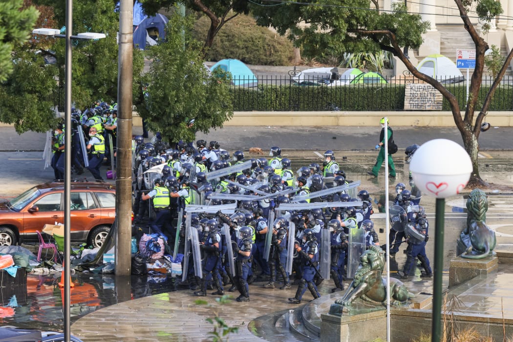 A tide of Police take the bottom of Lambton Quay.