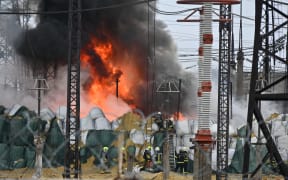 Firefighters extinguish a fire at an electrical substation after a missile attack in Kharkiv, on 22 March, 2024, amid the Russian invasion in Ukraine.