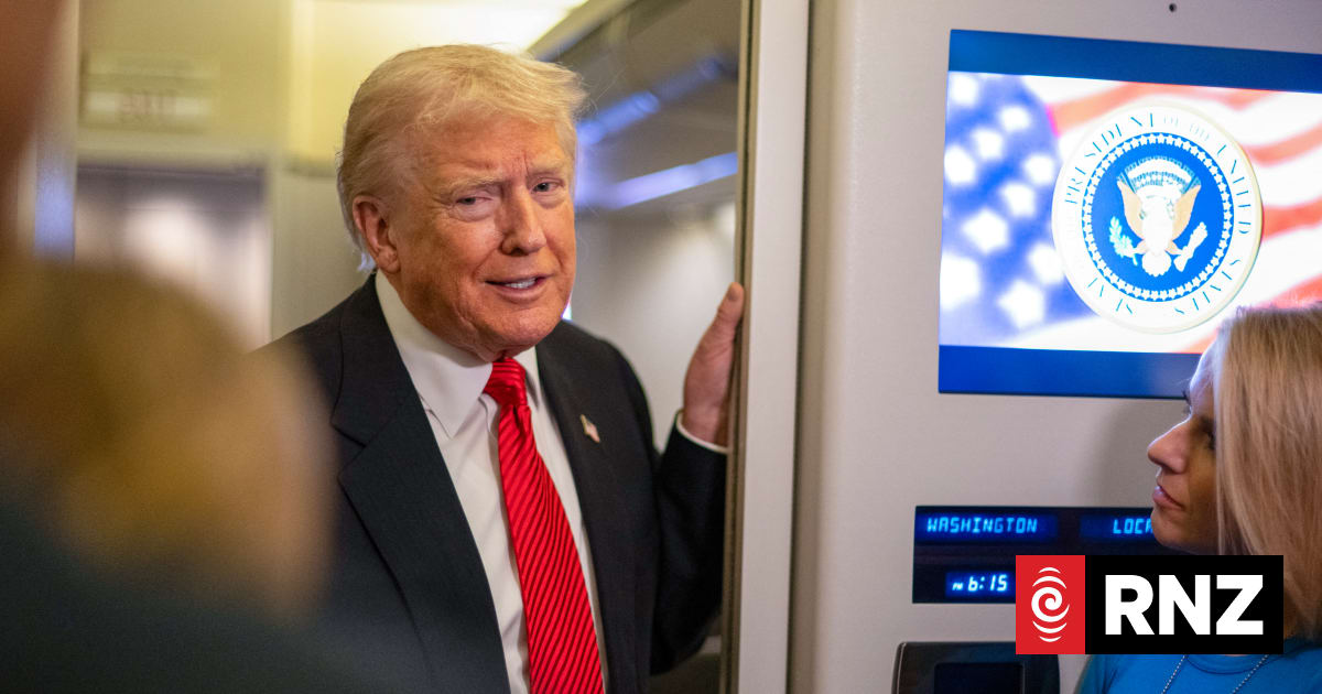 US President Donald Trump speaks to members of the press aboard Air Force One as he heads to Joint Base Andrews in Maryland