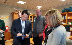 The Porteous and Keene families were in Wellington today meeting with National MPs to gather more signatures for a petition on random roadside drug testing. Simon Bridges (L).
