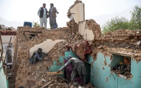Afghan earthquake survivors search through the remains of a damaged house at a village in Tashqurghan, in the Khulm district of Samangan province on 3 November, 2025. A 6.3-magnitude strong earthquake that struck overnight killed at least 20 people in northern Afghanistan, authorities said, just months after another deadly tremor that left the country reeling.