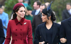 Britain's Catherine, Duchess of Cambridge (L) talks to Meghan, Duchess of Sussex as they arrive for the Royal Family's traditional Christmas Day service at St Mary Magdalene Church in Sandringham, Norfolk, eastern England, on December 25, 2018.