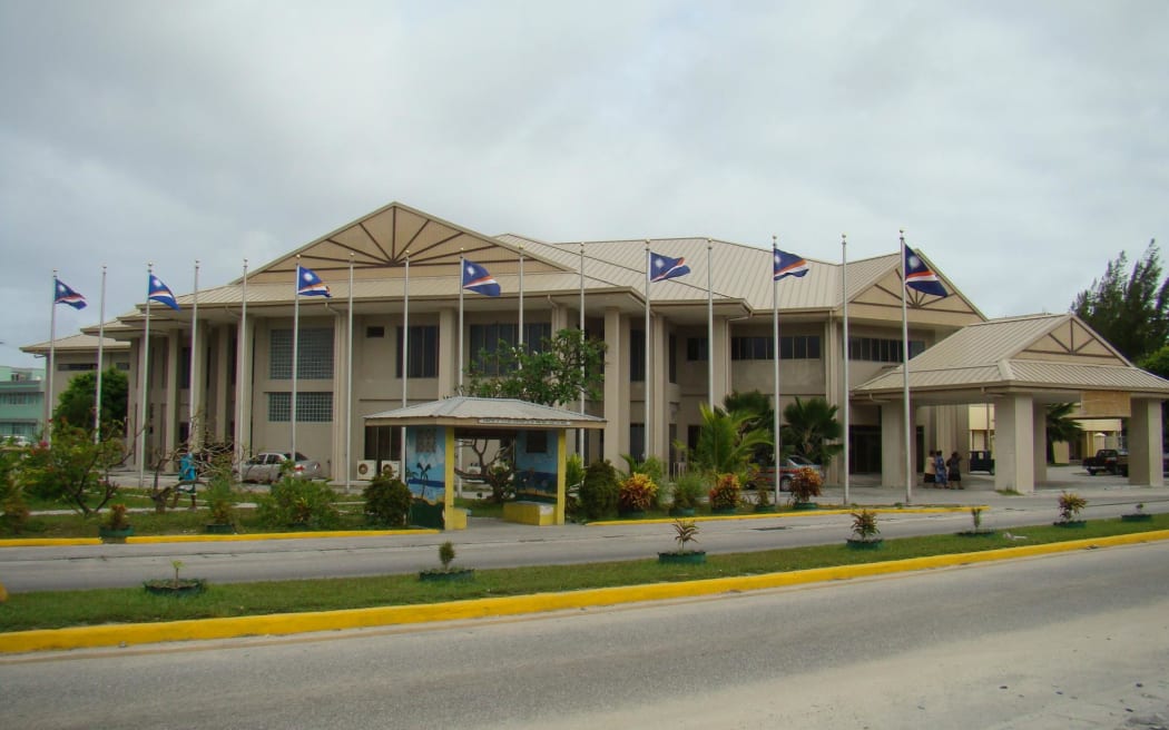 Marshall Islands flags fly in front of the capital building in Majuro. An audit of the government's passport office has found numerous problems and "ineffective" management.