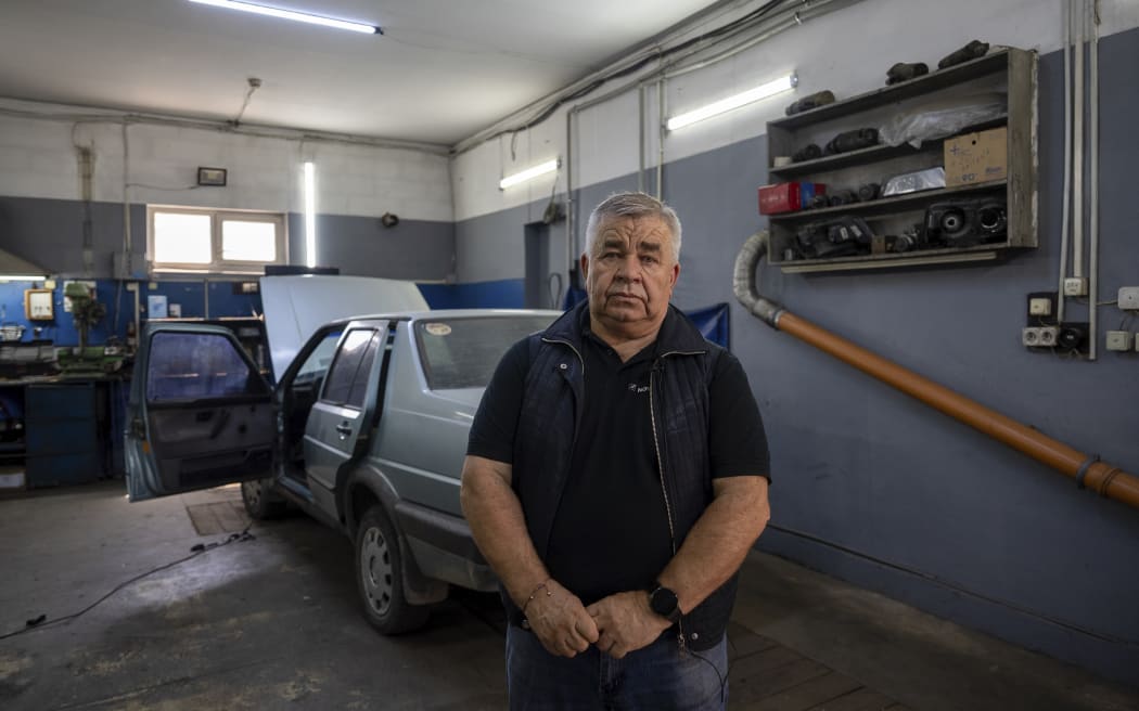 Oleksii, 68, director of the auto repair shop poses for photo in Kyiv region, Ukraine, Saturday, May 18, 2024. A divisive mobilisation law in Ukraine came into force on Saturday, as Kyiv struggles to boost troop numbers after Russia launched a new offensive.