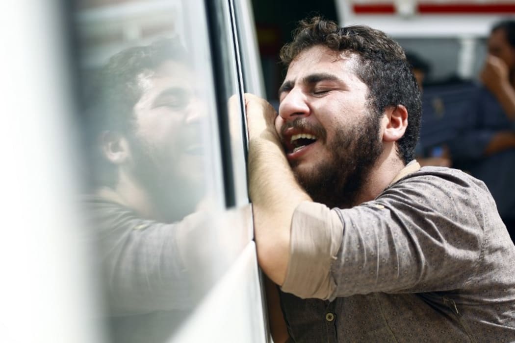 An Iraqi man mourns in the holy Iraqi city of Najaf during the funeral procession for the victims of a suicide bombing that ripped through Baghdad's busy shopping district of Karrada on July 3, 2016.