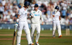 Tom Latham the New Zealand captain (R) runs over to congratulate Ben Stokes of England after he had been dismissed in his last test innings.