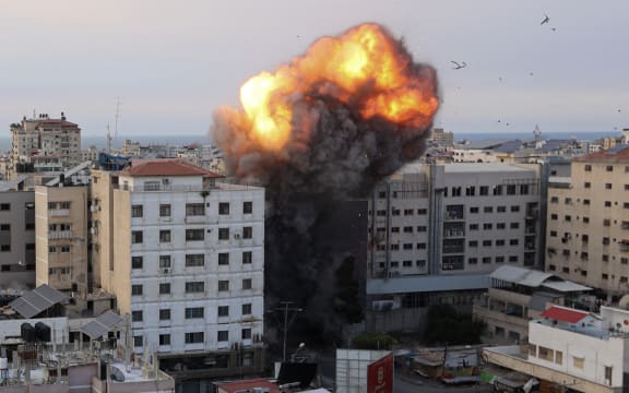 Fire and smoke rise after an Israeli air strike targeted the National Bank on Gaza City, on October 8, 2023.