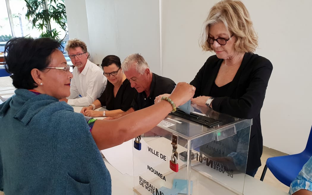 Noumea mayor Sonia Lagarde supervises the casting of the ballot paper to then announce 'voté!'