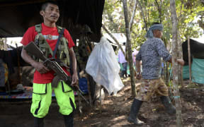 A member of the Colombian Revolutionary Armed Forces of Colombia (FARC) guerrilla, keeps watch at their camp in El Diamante, Caqueta Department, Colombia, on September 26, 2016