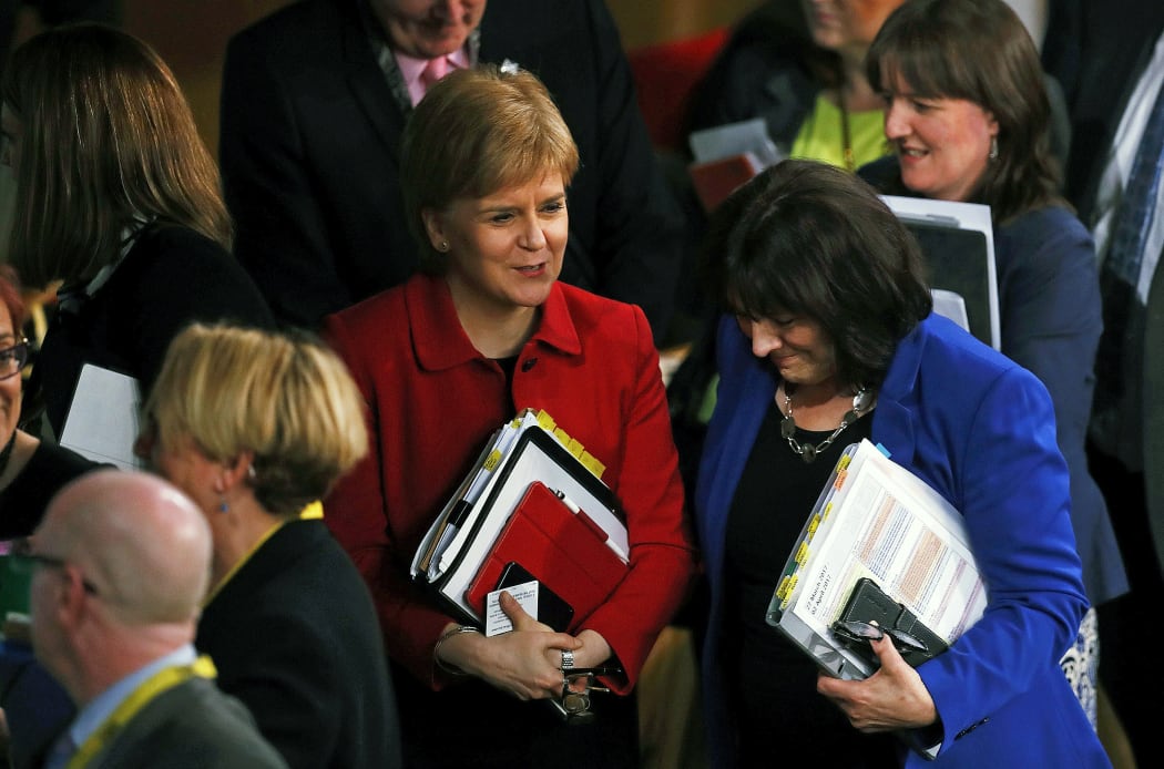 Scotland's First Minister Nicola Sturgeon (L) leaves after the vote on a second referendum on independence was carried at Scotland's Parliament in Holyrood, Edinburgh on March 28, 2017.