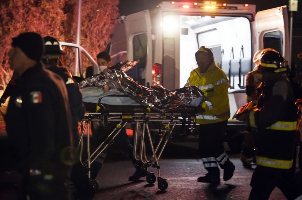 An injured person is transferred to a helicopter near the toll of Tepotzotlan,