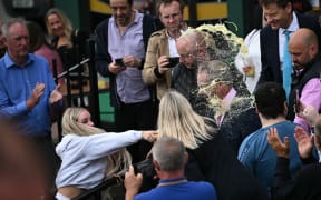 Image: A woman throws a drink in the face of newly appointed leader of Britain's right-wing populist party, Reform UK, and the party's parliamentary candidate for Clacton, Nigel Farage, during his general election campaign launch in Clacton-on-Sea, eastern England, on June 4, 2024.