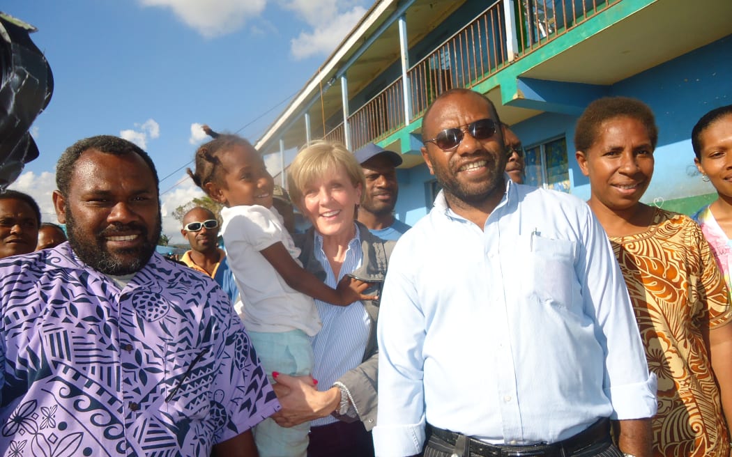 Australia's Foreign Minister Julie Bishop holds a ni-Vanuatu child while visiting in the wake of Cyclone Pam.