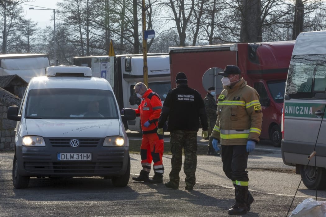 Polish Border control guards, medical worker and soldiers carry out temperature checks at the Lubawka border crossing between Poland and the Czech Republic.