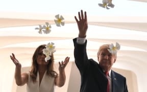 US President Donald Trump and First Lady Melania Trump throw flowers during their visit to the USS Arizona Memorial in Hawaii.