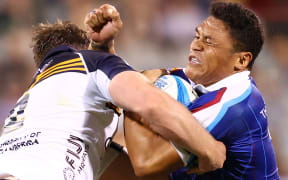 Caleb Clarke of the Blues is tackled during the round three Super Rugby match between ACT Brumbies and Auckland Blues at GIO Stadium.