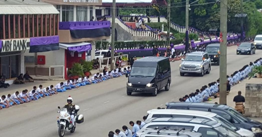 The Queen Mother Halaevalu Mata'aho's body is taken through the Nuku'alofa with students paying respect