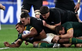 South Africa's full-back Damian Willemse is tackled during the 2023 Rugby World Cup Final between New Zealand and the Springboks at the Stade de France.