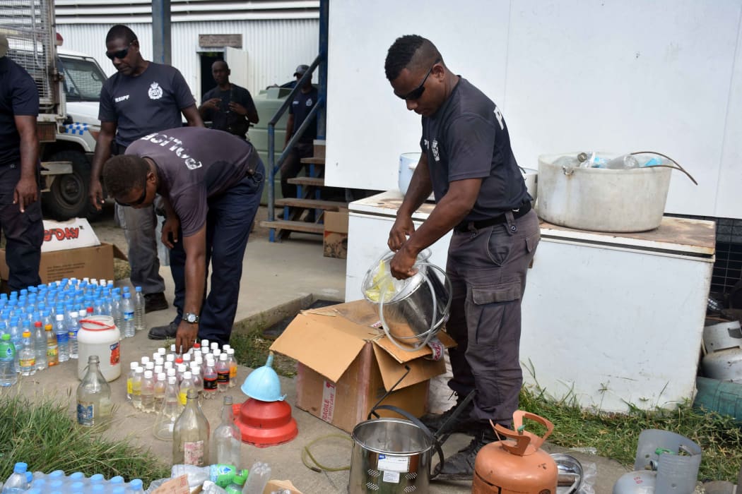 Solomon Islands police with seized kwaso.