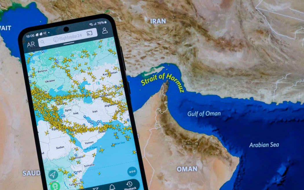 A map shows current air traffic across the Middle East on a laptop and smartphone in this photo illustration, as airlines reroute or cancel flights following escalating conflict involving Iran that leads to widespread airspace closures and major disruption to global aviation routes in Brussels, Belgium, on March 5, 2026. (Photo by Jonathan Raa/NurPhoto) (Photo by Jonathan Raa / NurPhoto via AFP)
