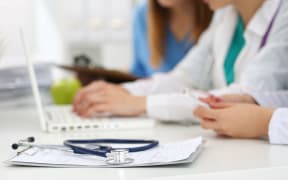 Healthcare staff, doctors, nurse, working on laptop.