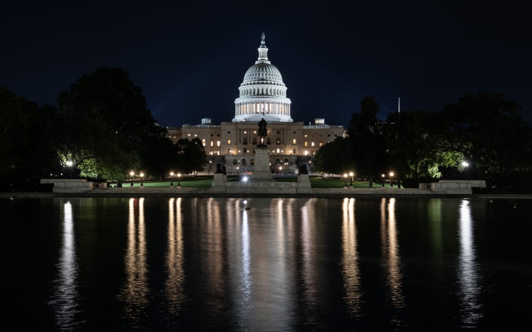 The US Capitol is seen lit up hours before a partial government shutdown is set to take effect in Washington, DC, on September 30, 2025. The US government barreled towards its first shutdown in six years Tuesday, with funding expiring at midnight after Democrats fought a war of words with Donald Trump and senators rejected a last-ditch bid to keep the lights on. (Photo by ANDREW CABALLERO-REYNOLDS / AFP)
