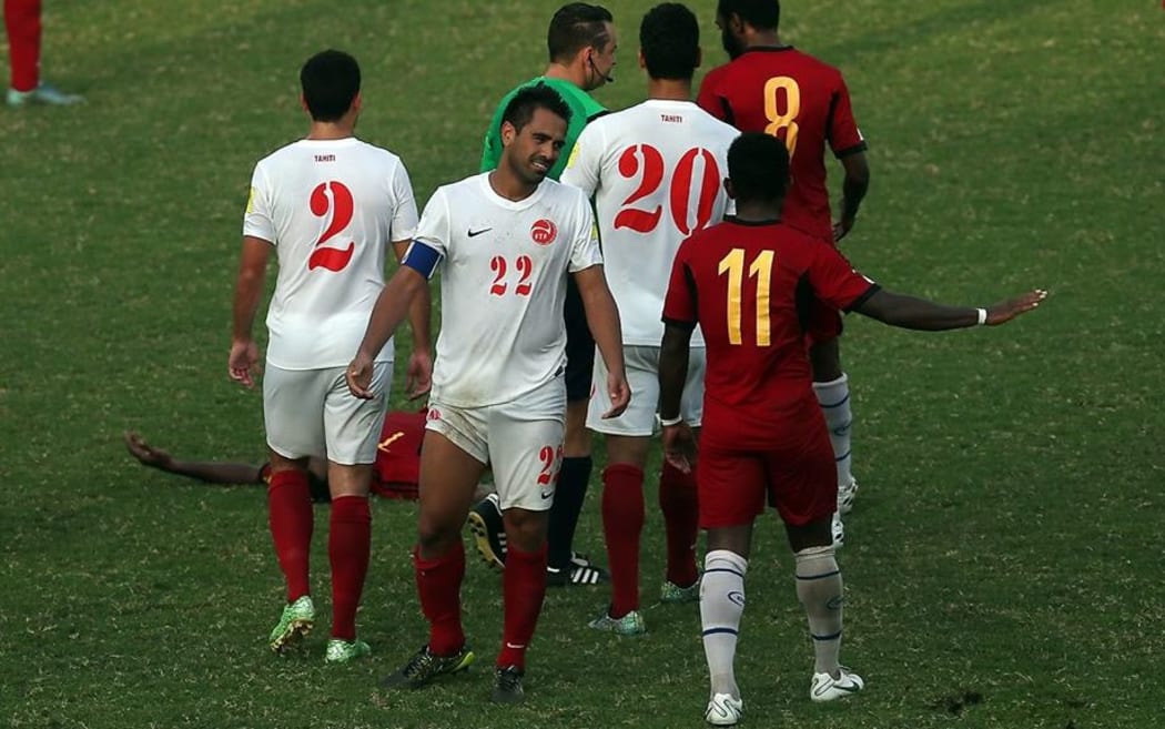 Tahiti's Nicolas Vallar is sent off for a challenge on PNG's Raymond Gunemba.
