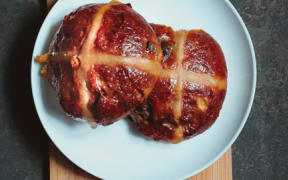 A hot cross bun on a plate