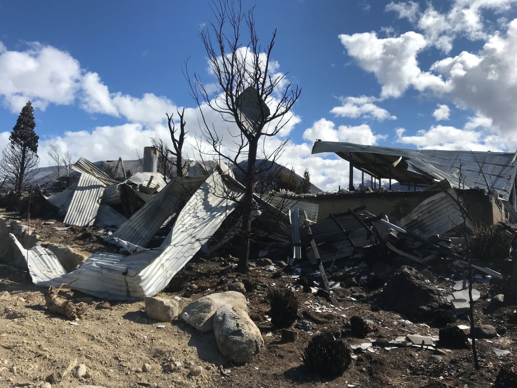 The remains of a property strewn across the land after a fire ripped through Lake Ōhau Village.