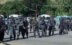 Police stand at the students protests.