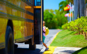 School kid, child, boy, getting on bus.