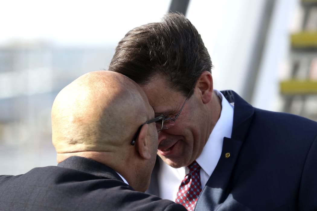 New Zealand Defence Minister Ron Mark receives US Secretary of Defense Mark Esper (R) at Auckland International airport on August 5, 2019. - Esper is in New Zealand for two days to hold bilateral meetings.