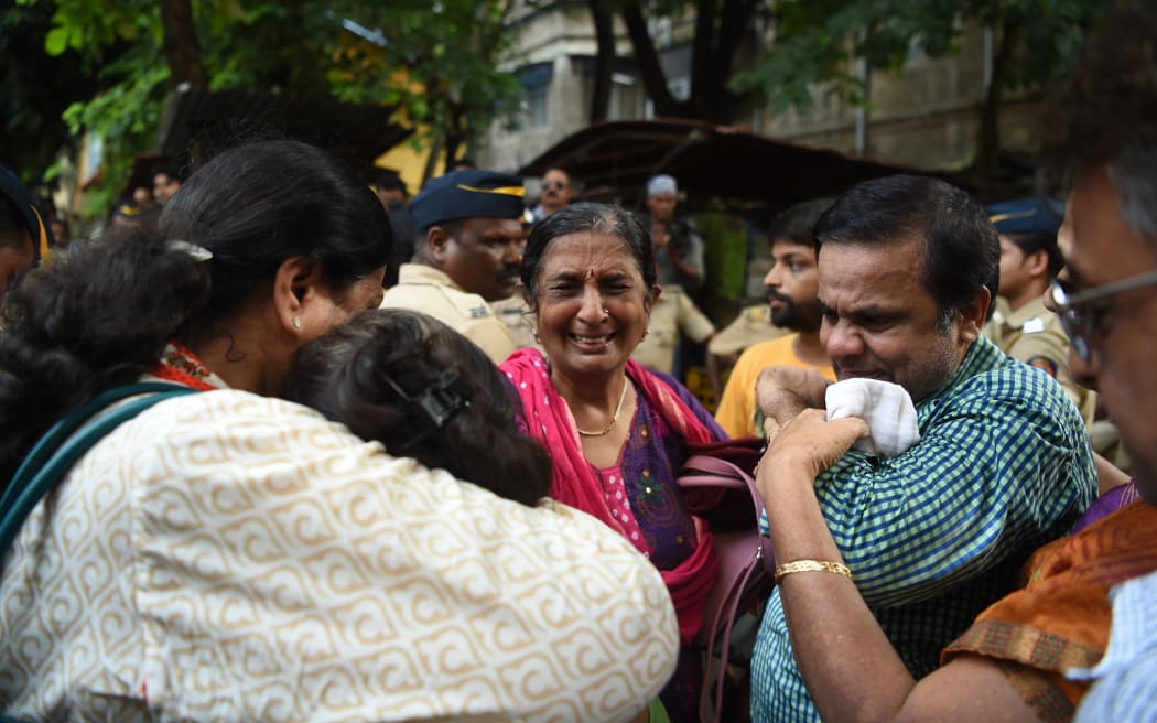 Relatives grieve outside a mortuary where the bodies of stampede victims were taken