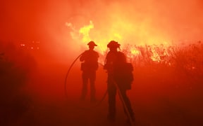 Firefighters from the Los Angeles Fire Department (LAFD) and other firemen respond to the Post Fire as it burns through the Hungry Valley State Vehicular Recreation Area in Lebec, California, on June 16, 2024. The fire has grown to 4,400 acres, with evacuation orders in place for Gorman, Pyramid Lake and Hungry Valley State Vehicular Recreation Area, according to the US Department of Agriculture Forest Service at Los Padres National Forest. (Photo by DAVID SWANSON / AFP)