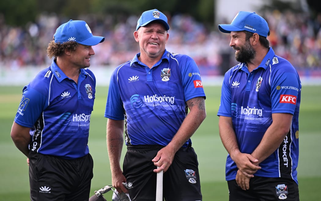 Lou Vincent (C) shares a joke with Team Cricket team-mates Hamish Marshall (L) and Anton Devcich during the T20 Black Clash cricket match in Christchurch.